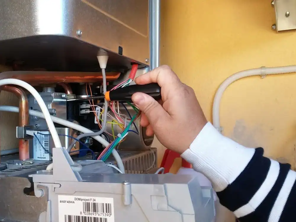 Technician servicing a home water heater